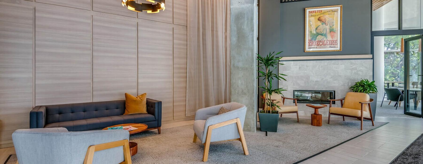 a room with a couch and chairs