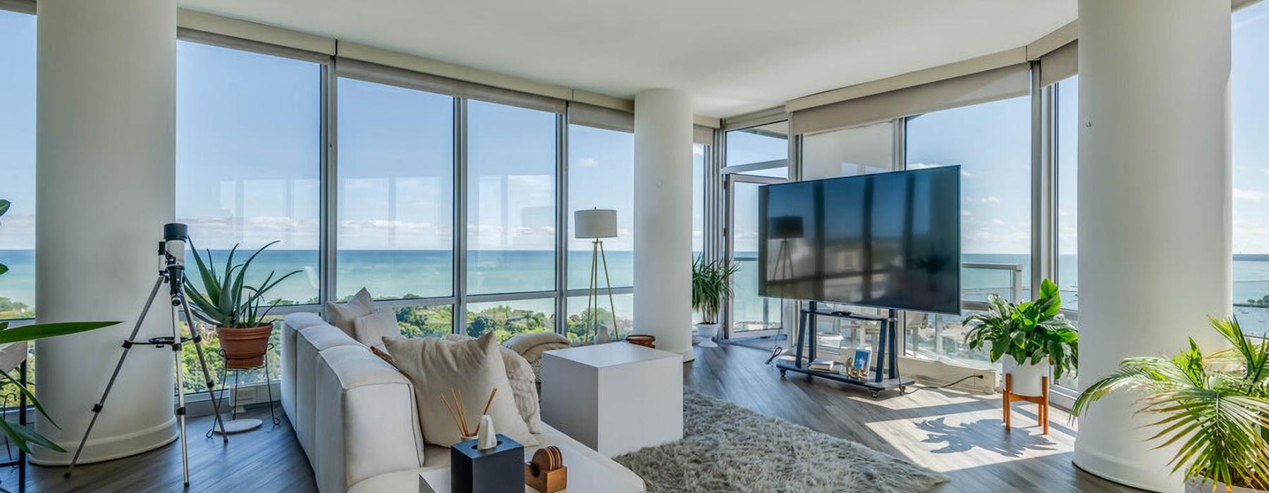 a living room with a large window and large tv